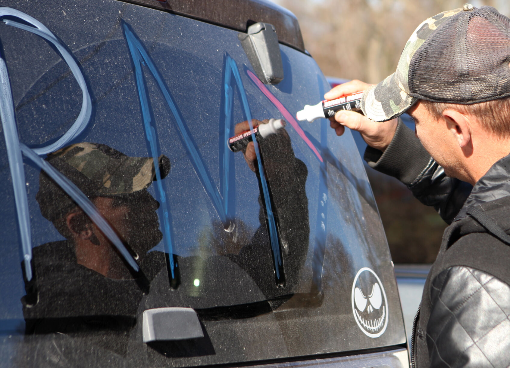 Kenny Momphard paints his windshield